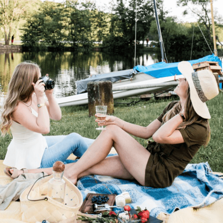 Women at lake taking photos of each other for blog: 6 FUN WELLNESS ROUTINES FOR SPRING