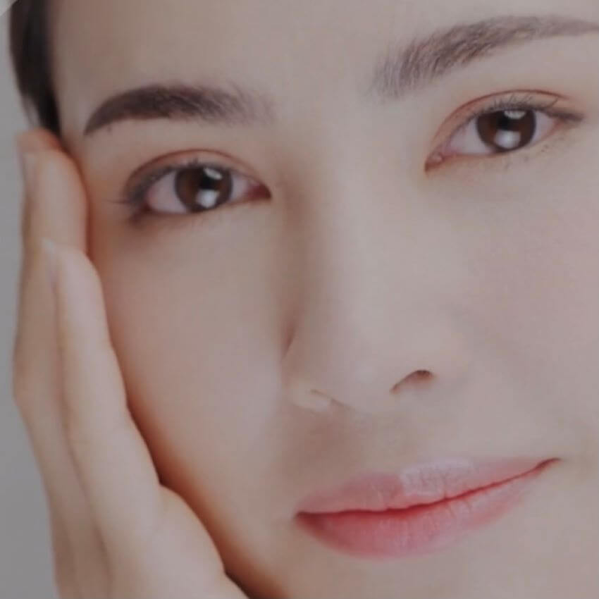 Woman holding her hand up to her face for blog: HOW LONG DO ACTIVE SKINCARE INGREDIENTS TAKE TO WORK?
