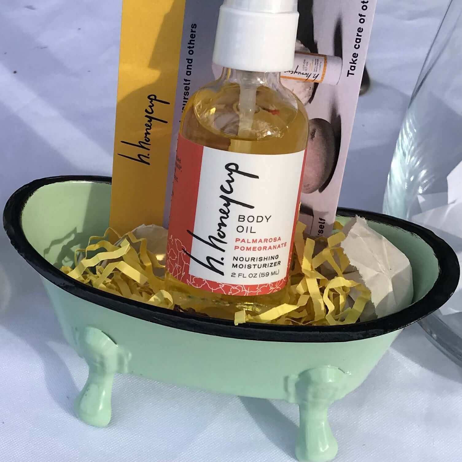 body oil in green metal bathtub