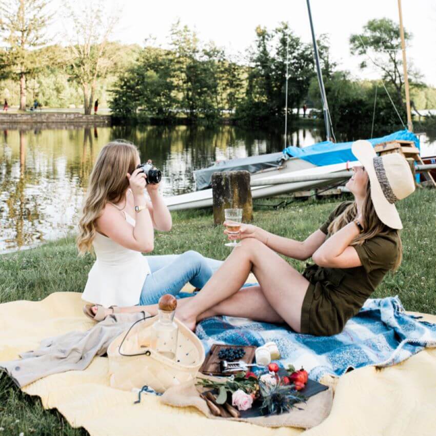 Two women on blanket at outdoor photo shoot for blog: SPRING GIFT GUIDE BY H. HONEYCUP