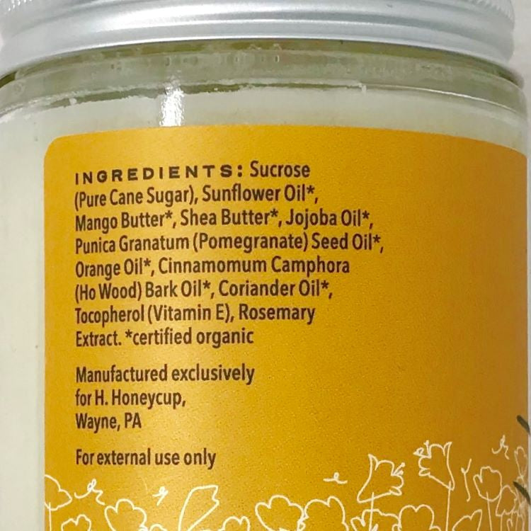 Image of back side of H. Honeycup Orange Body Scrub. Natural ingredients are shown for blog on how to read clean skincare labels