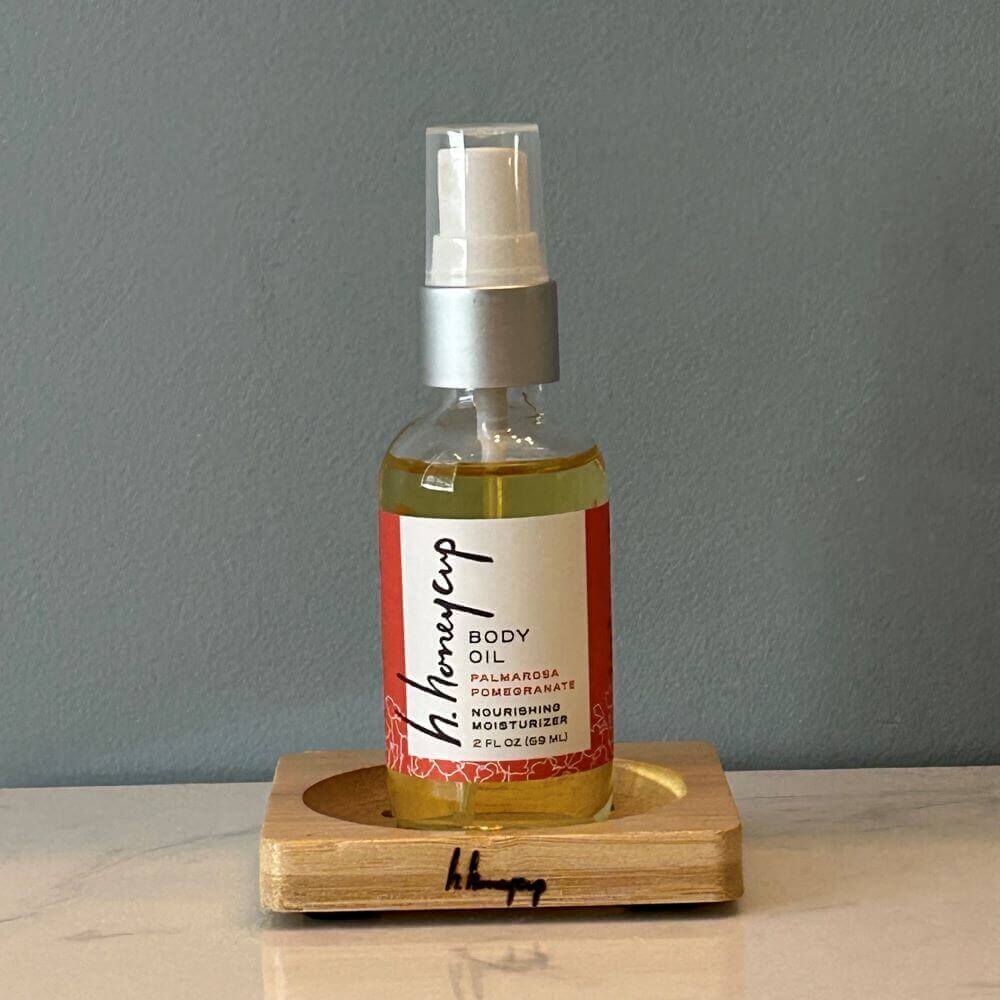 body oil resting on bamboo soap dish